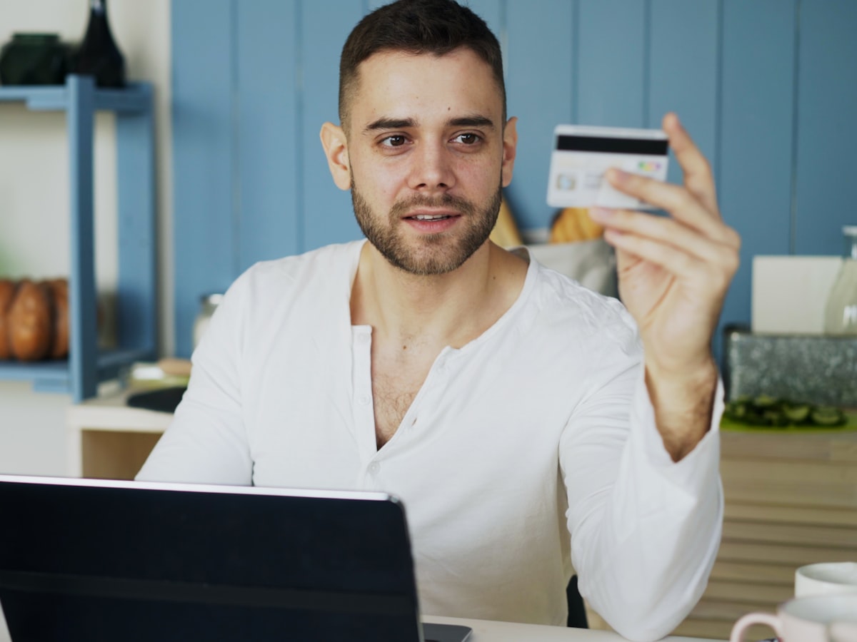 Man shopping online with laptop and credit card