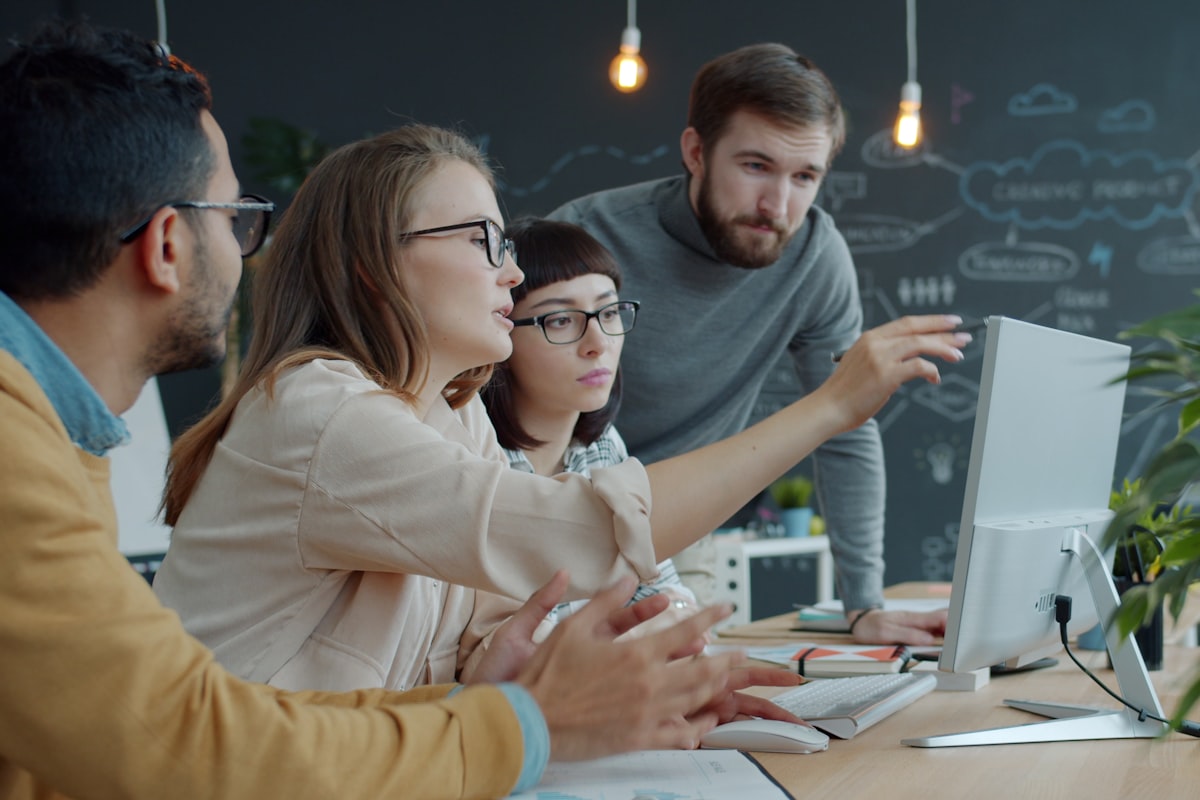 Web development team collaborating in office